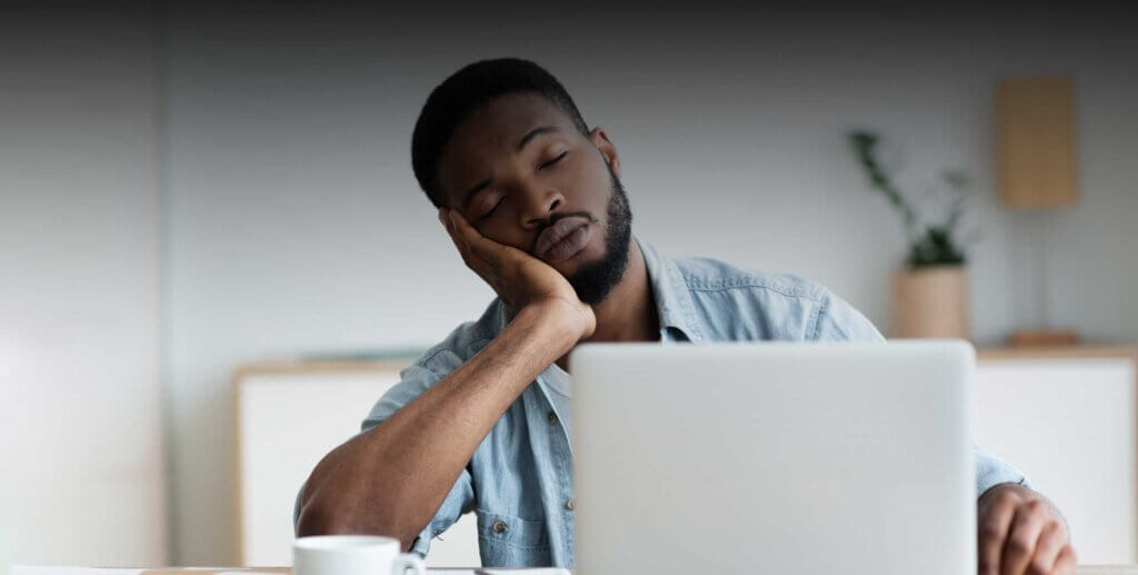 a man asleep at his computer