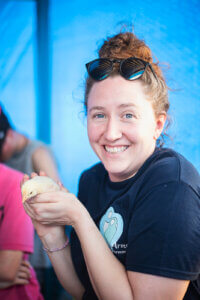 Shannon with the baby chick - Our MWF grant helped fund the Chicken Co-Op